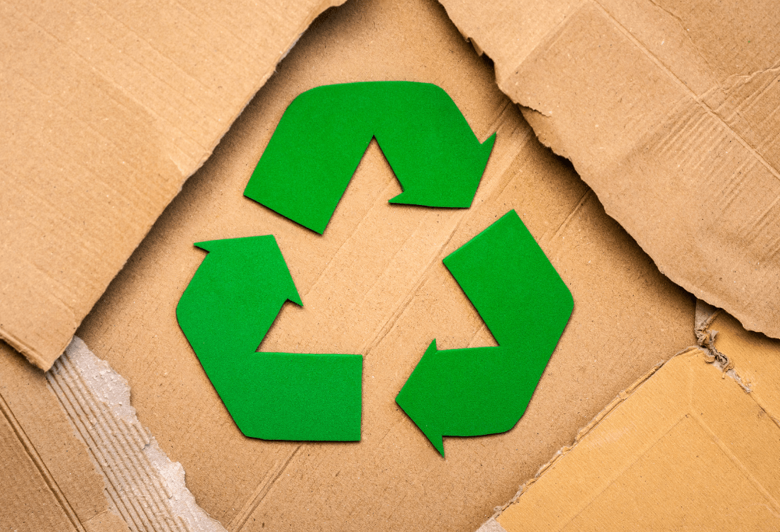 A recycle sign on packaging that has been affected environmentally and economically.